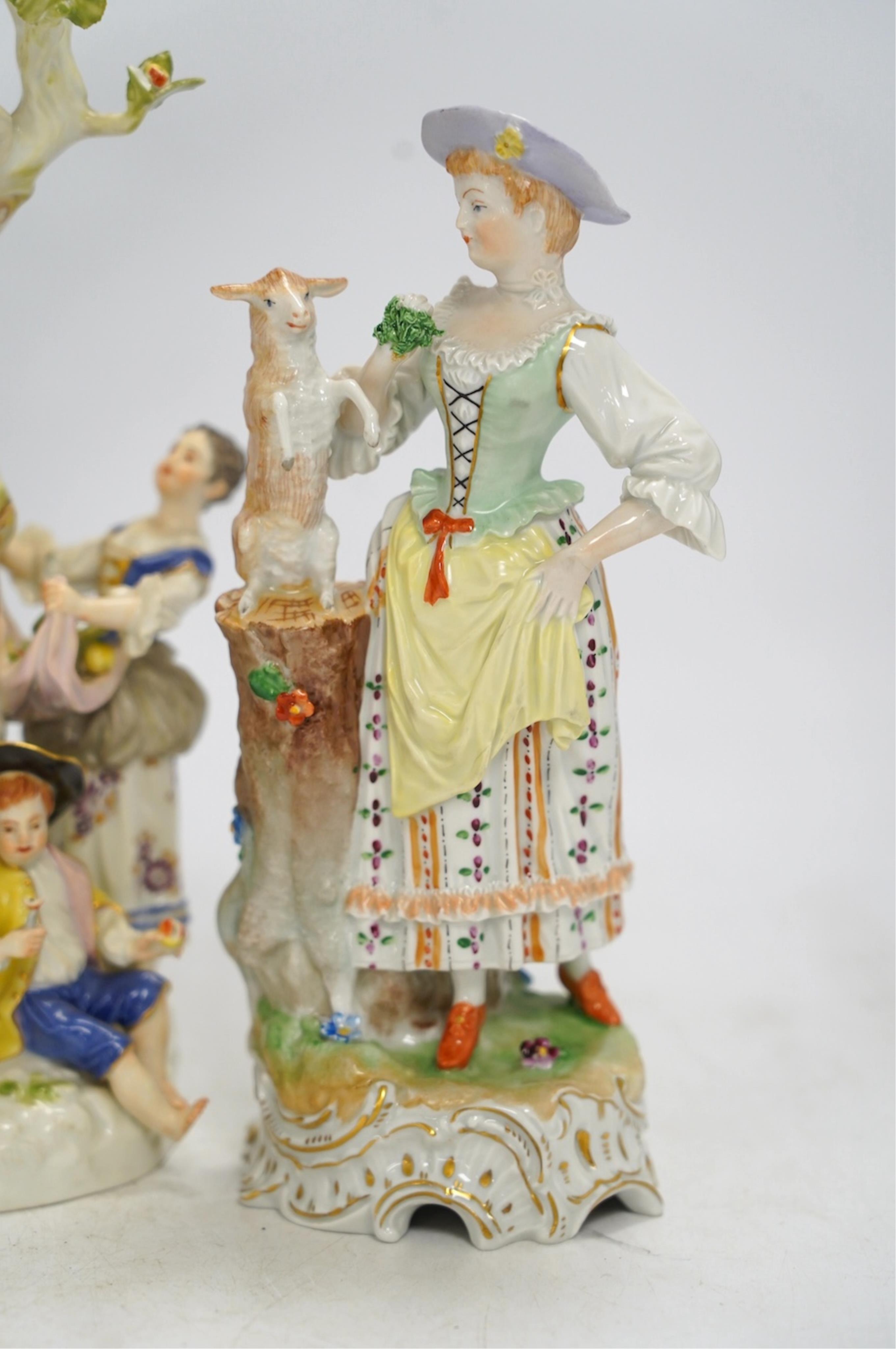 A Meissen apple pickers figure group and a pair of Dresden porcelain groups, tallest 29cm. Condition - some damage